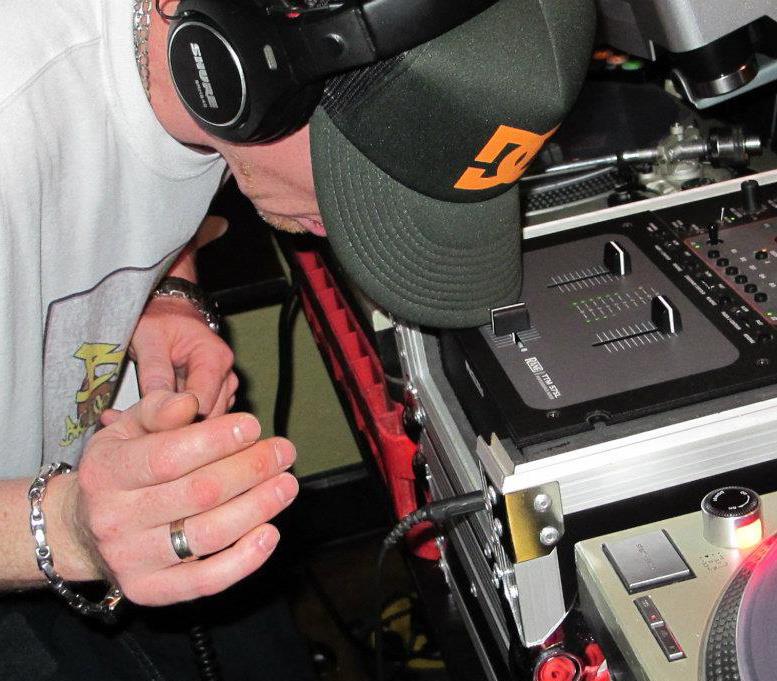 DJ Natural Nate® on the DC hat and Lost Art shirt working the decks